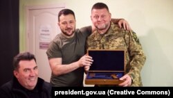 Президент Украины Владимир Зеленский, главнокомандующий ВСУ Валерий Залужный (справа), получивший от главы государства наградное оружие, и секретарь СНБО Алексей Данилов (слева). Днепо, 27 июля 2023 года