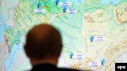 Russia -- Russian President Vladimir Putin looks at Russian map during a live-broadcasted test-launch of the Russia's Angara-A5 new heavy-class rocket from the Plesetsk cosmodrome in the Arkhangelsk region, December 23, 2014